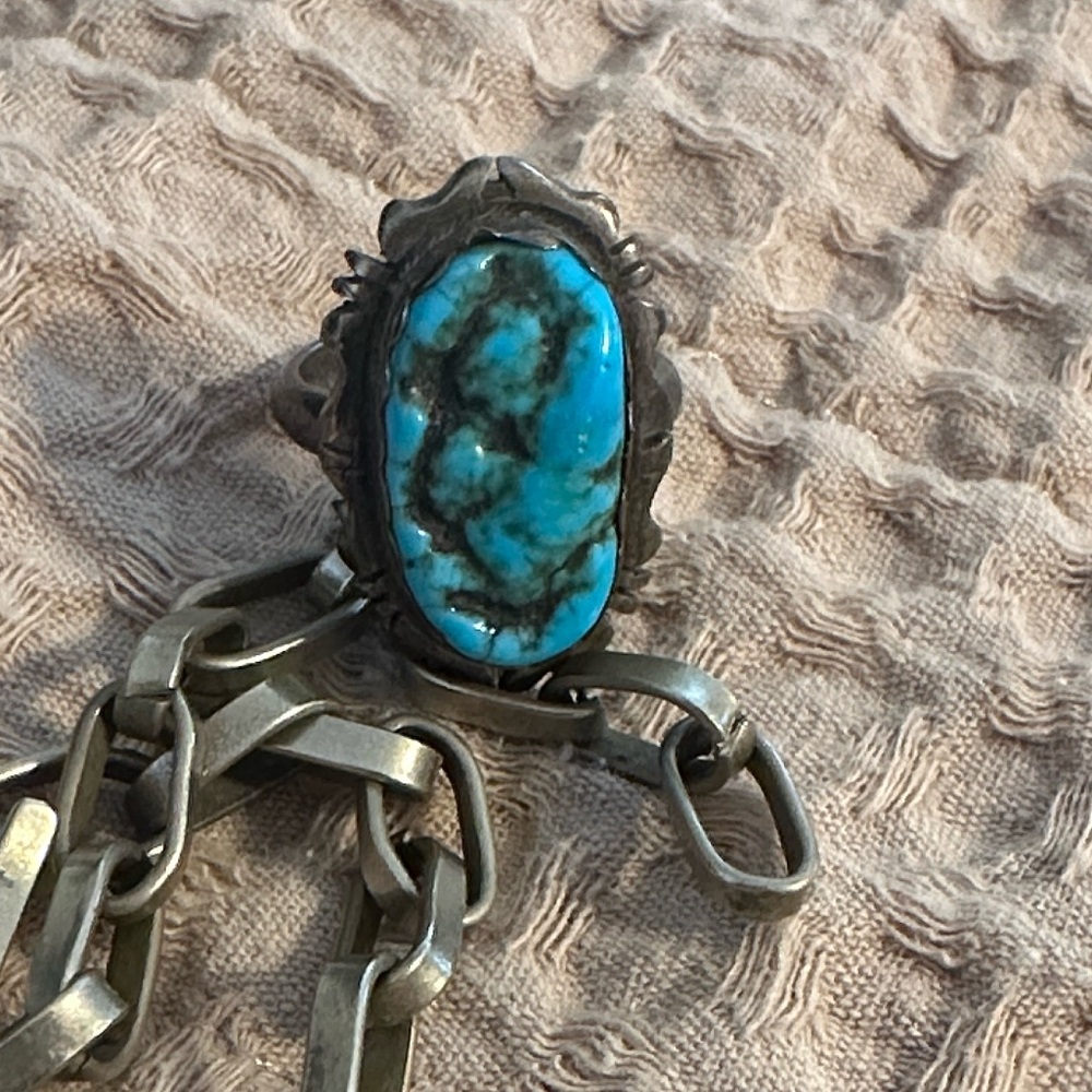 Turquoise ring stamped with designer